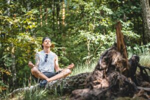 Man sat meditating in outdoors